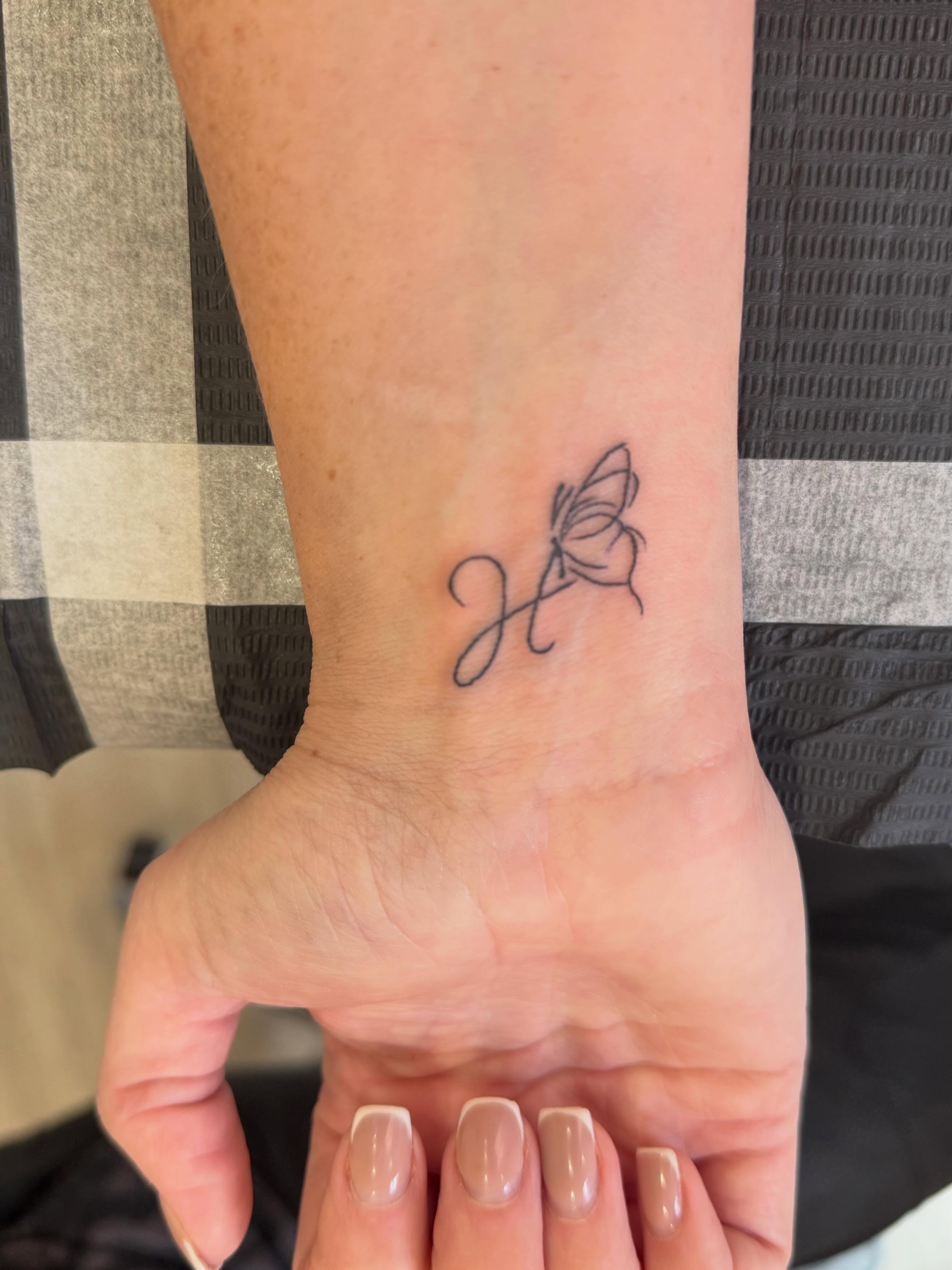 H and a butterfly