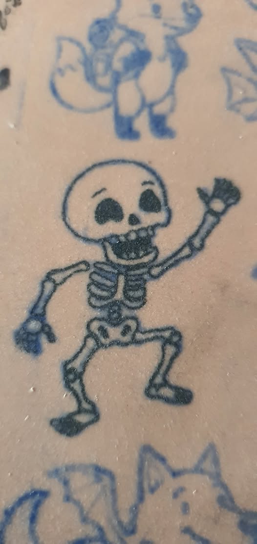 Mini skeleton tattoo detail