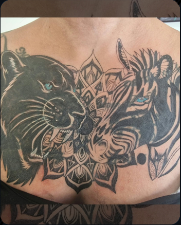 Panther and zebra chest tattoo with ornamental mandala design