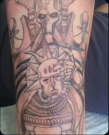 Warhammer 40K Necron holding Blood Angels head in a detailed black and grey tattoo